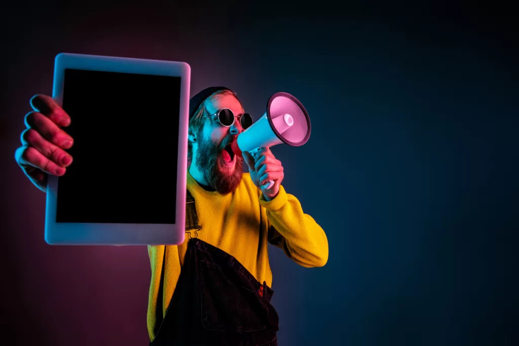 Caucasian man's portrait isolated on gradient studio background in neon light